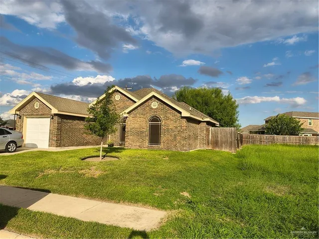 a view of big yard with a house in the background