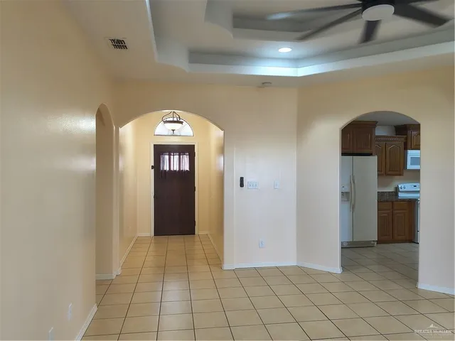 a view of a hallway to rooms and stairs