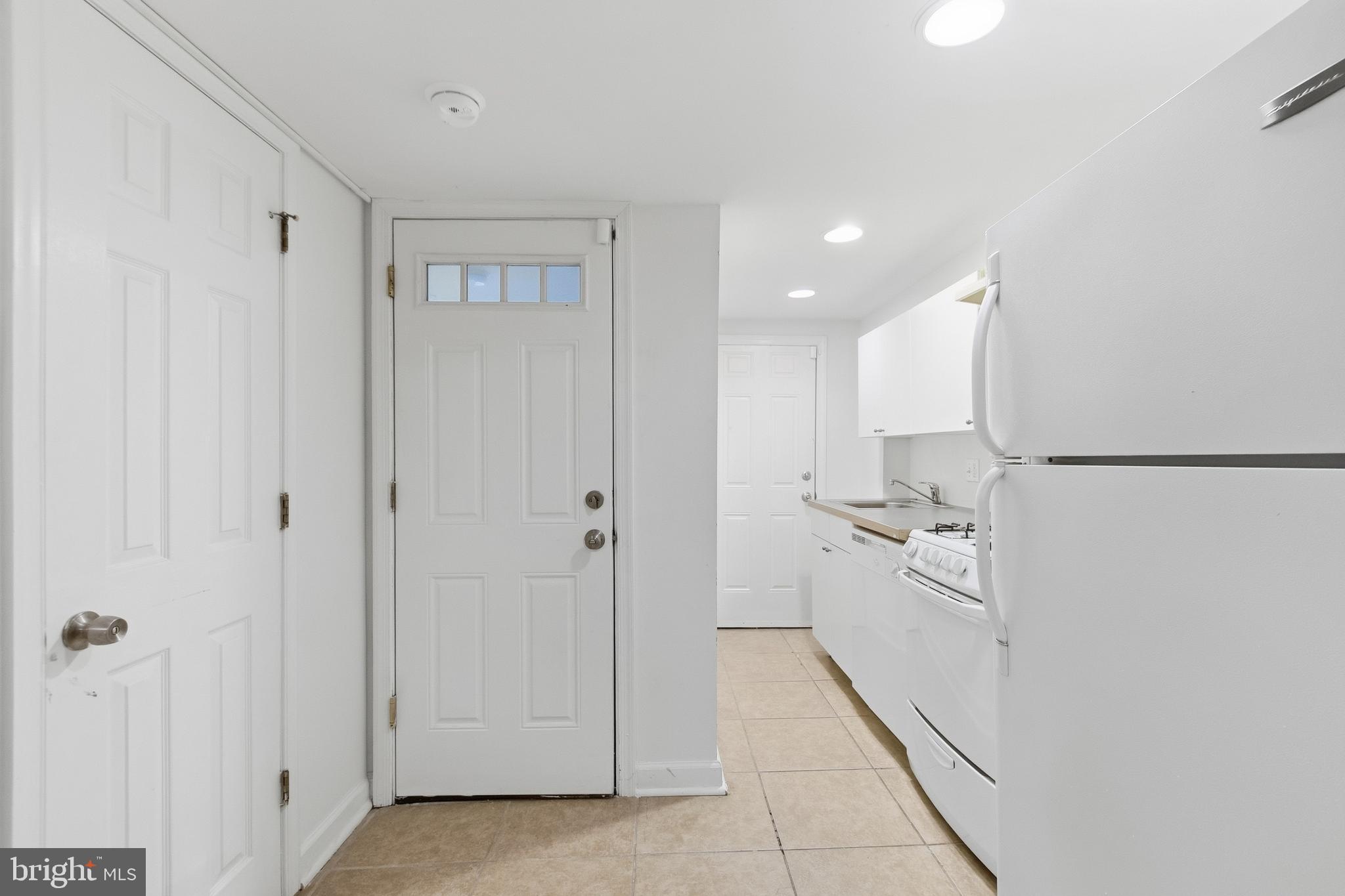 440 Delafield Place Northwest Washington, DC 20011 - Photo 24 of 33 a hallway with white cabinets and stainless steel appliances