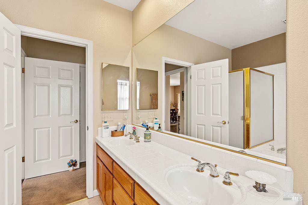 6252 Meadowstone Drive Santa Rosa, CA 95409 - Photo 33 of 33 a bathroom with a double vanity sink and a mirror