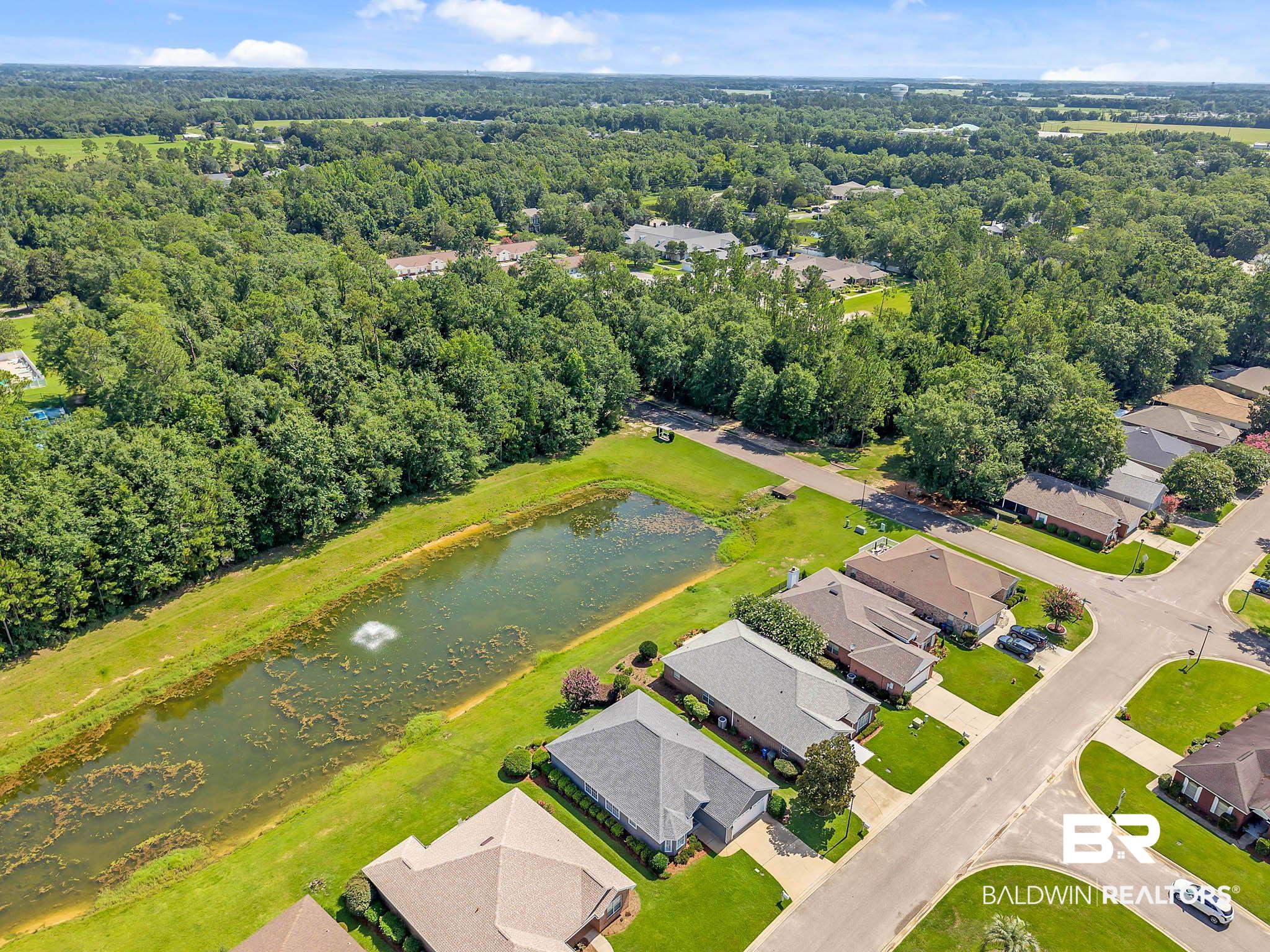 213 Hemingway Loop Foley, AL 36535 - Photo 8 of 69 Aerial view of residential area featuring a nearby body of water and a forest