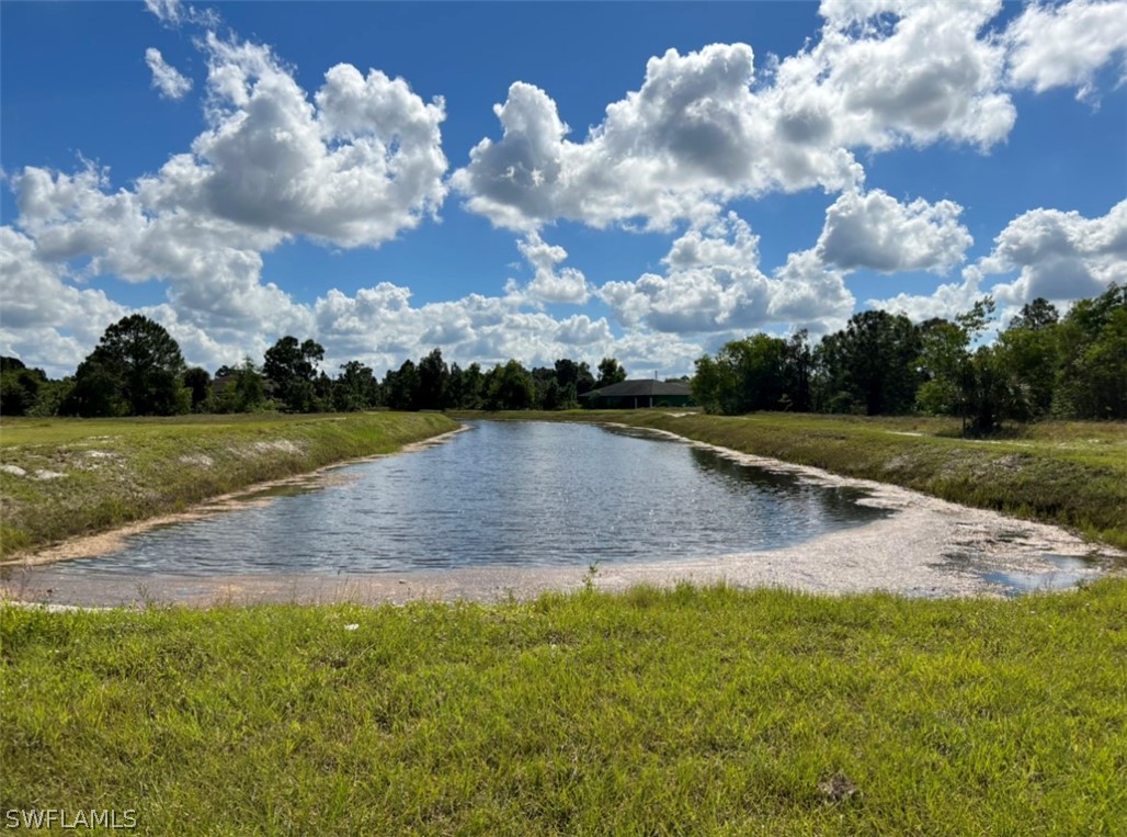 427 Jourferie Road Lehigh Acres, FL 33974 - Photo 10 of 10 a view of a yard with swimming pool and green space