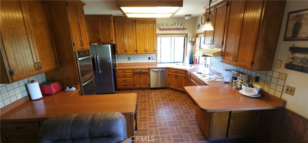 25205 5th Avenue Los Molinos, CA 96055 - Photo 13 of 37 a kitchen with stainless steel appliances a sink stove and refrigerator