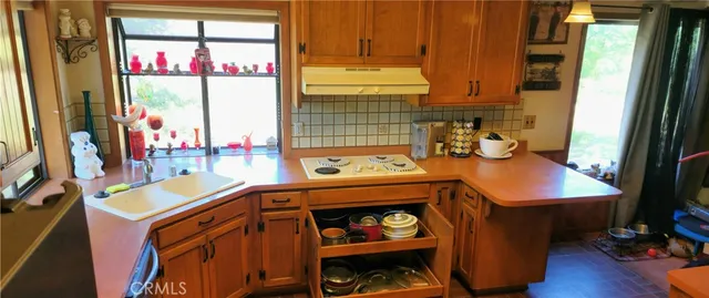 a kitchen with stainless steel appliances granite countertop a refrigerator and a stove