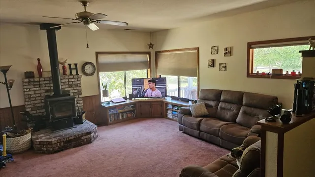 a view of a livingroom with furniture and a window