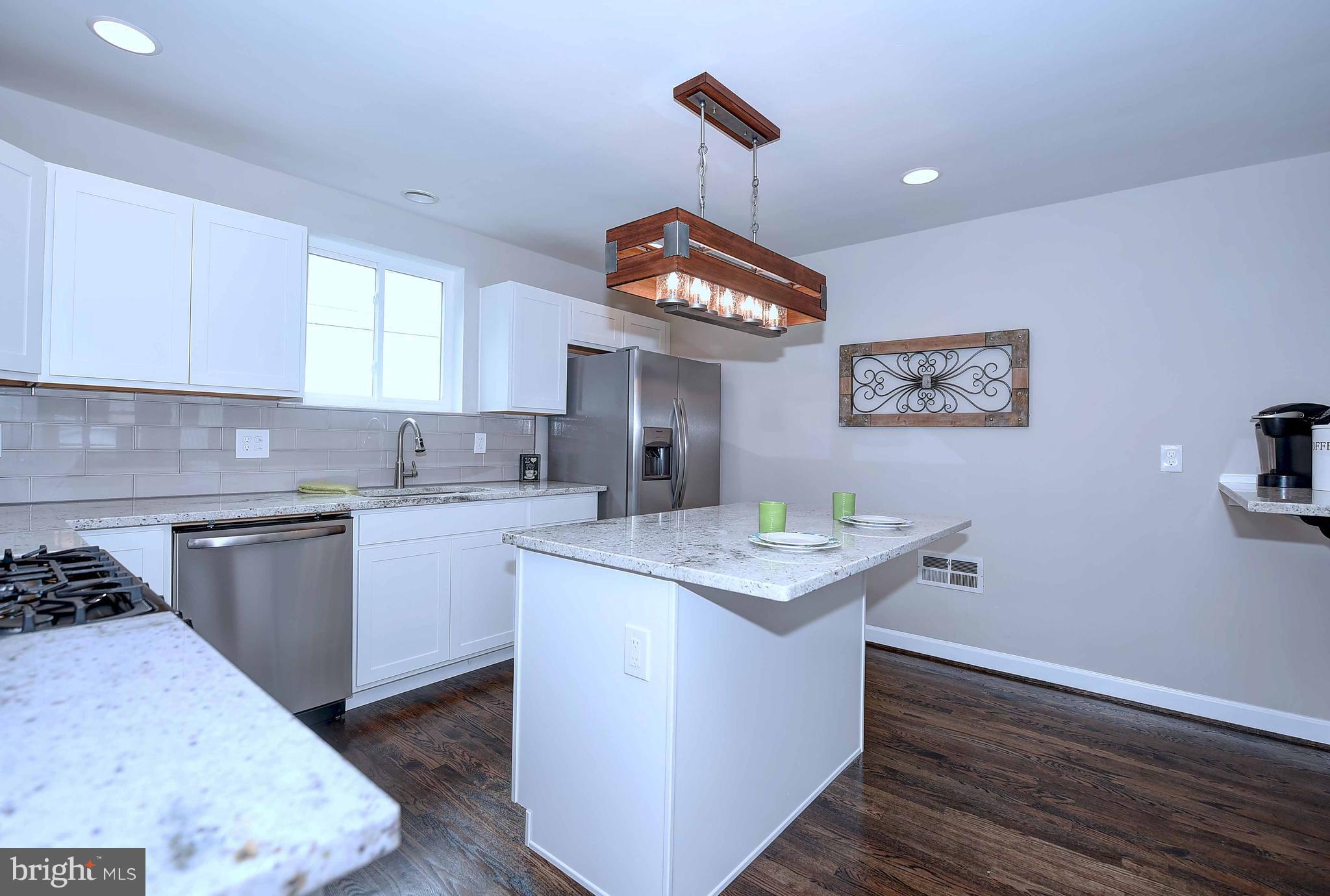 1213 Ridgeshire Road Baltimore, MD 21222 - Photo 12 of 30 a kitchen with a stove and cabinets