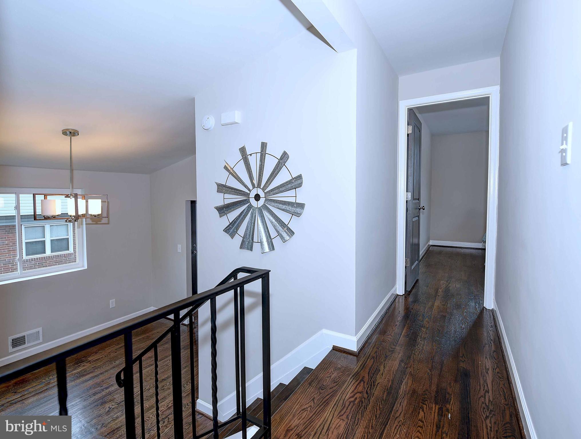 1213 Ridgeshire Road Baltimore, MD 21222 - Photo 14 of 30 a view of a hallway with wooden floor and staircase