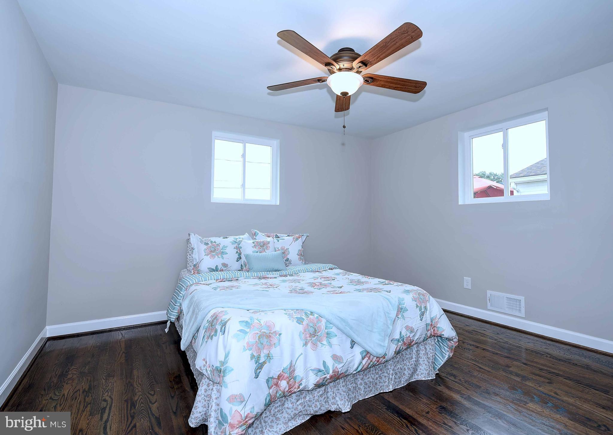 1213 Ridgeshire Road Baltimore, MD 21222 - Photo 15 of 30 a bedroom with a large bed and a large window