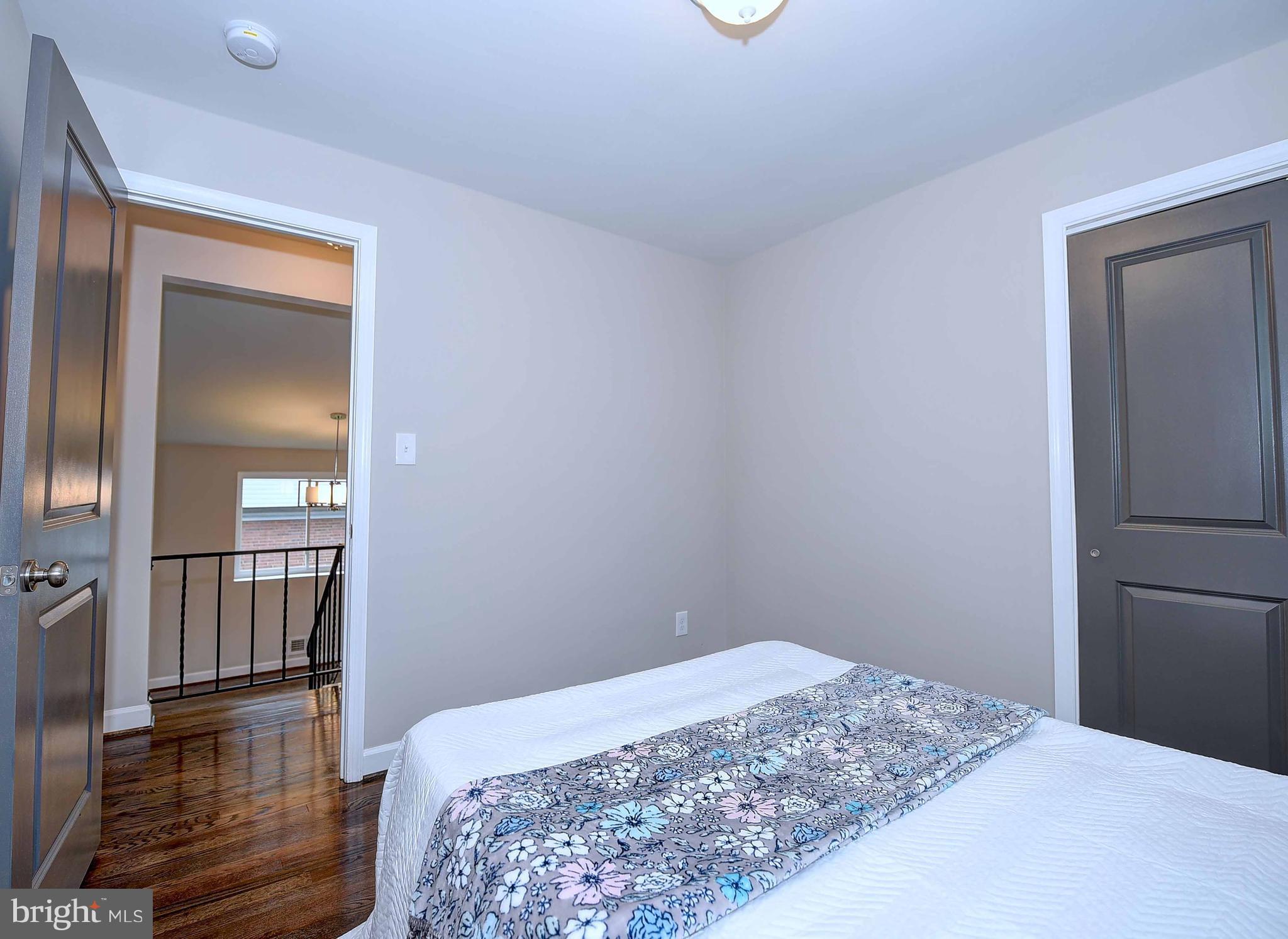 1213 Ridgeshire Road Baltimore, MD 21222 - Photo 17 of 30 a bedroom with a bed and wooden floor