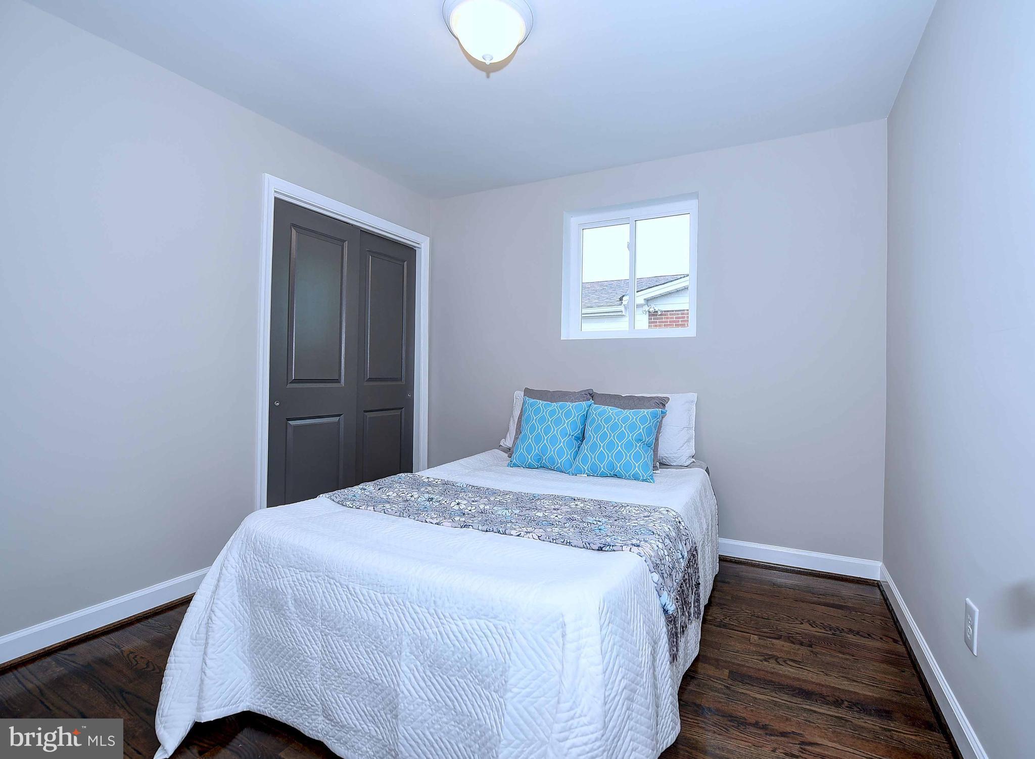1213 Ridgeshire Road Baltimore, MD 21222 - Photo 18 of 30 a bedroom with a bed and wooden floor