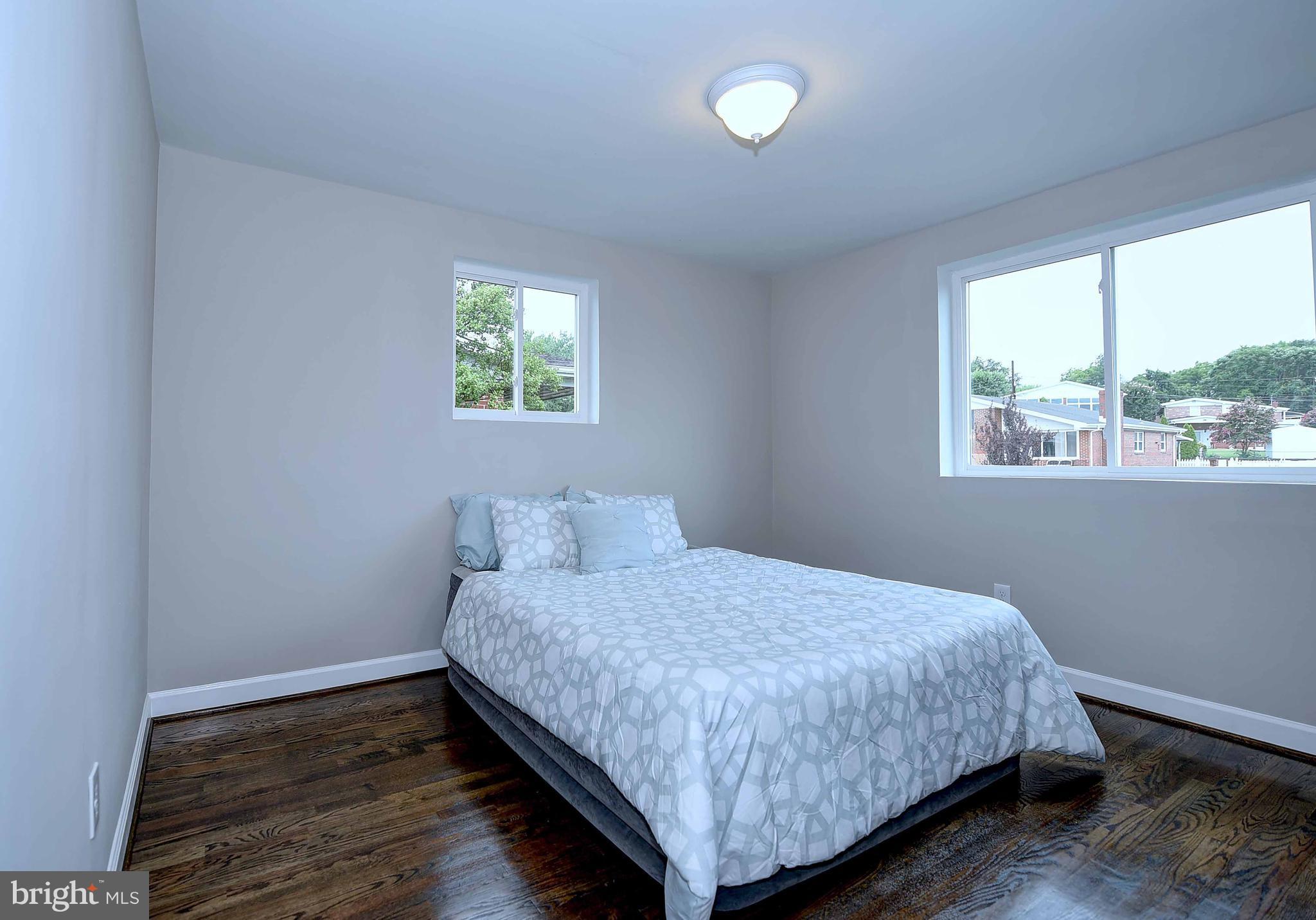 1213 Ridgeshire Road Baltimore, MD 21222 - Photo 20 of 30 a bedroom with a bed and window