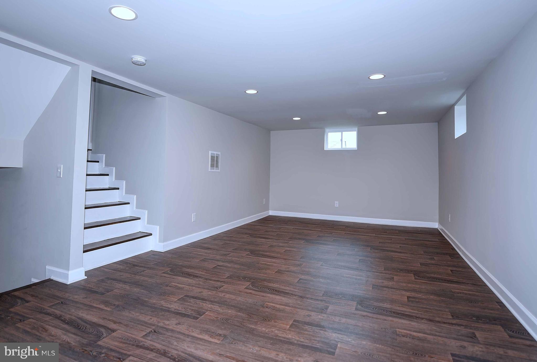1213 Ridgeshire Road Baltimore, MD 21222 - Photo 22 of 30 a view of an empty room with wooden floor