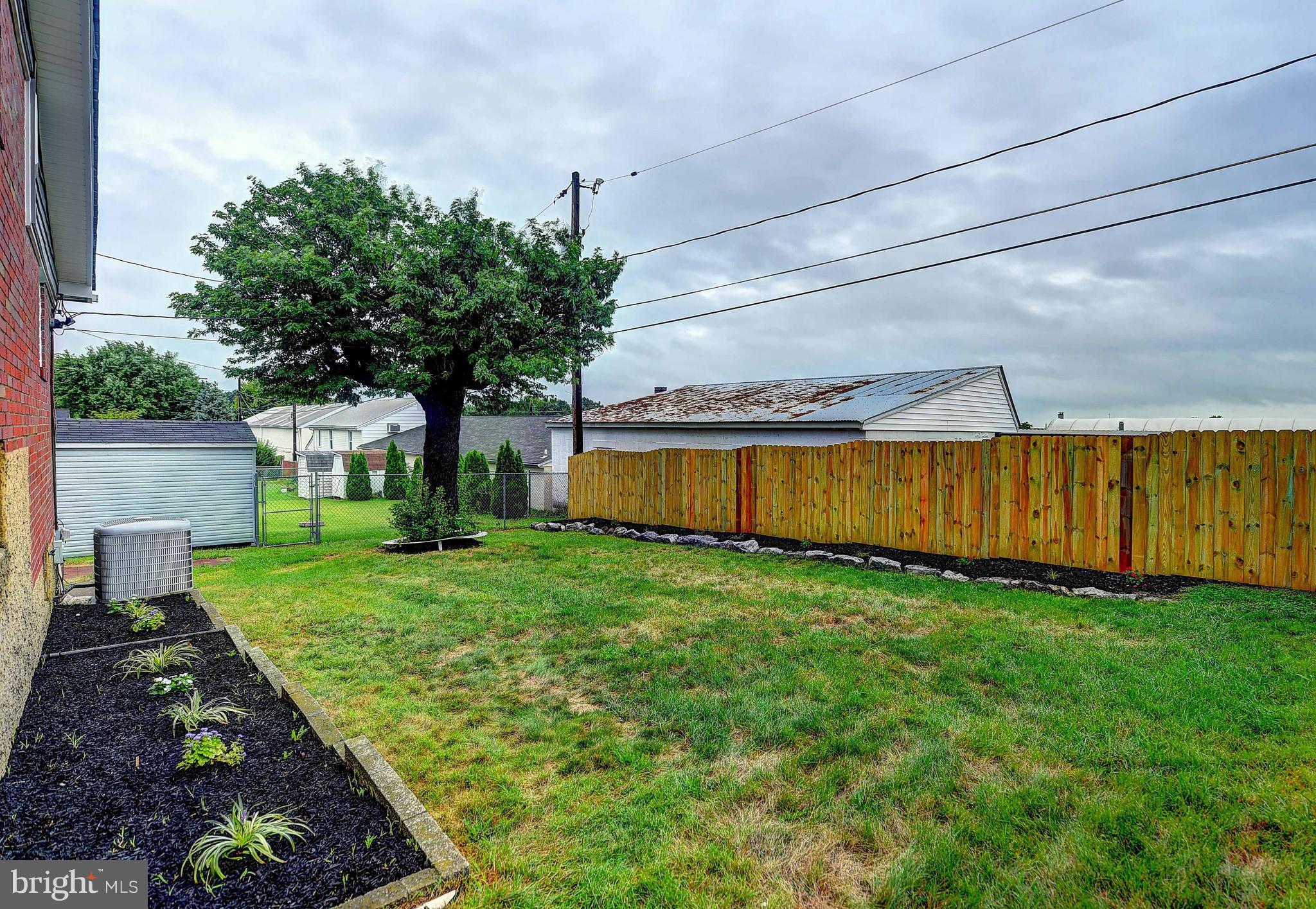 1213 Ridgeshire Road Baltimore, MD 21222 - Photo 29 of 30 a view of a backyard with plants and large trees