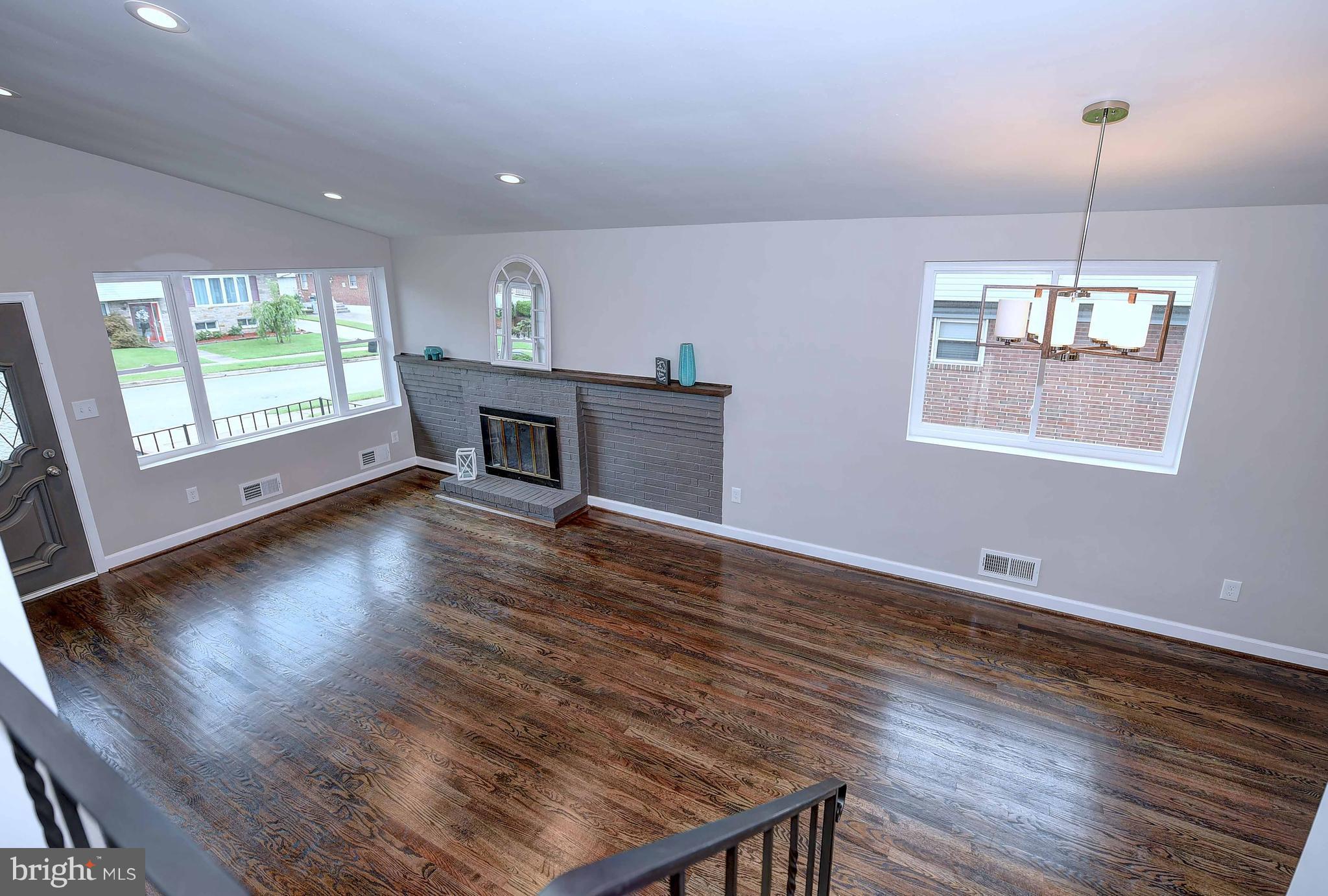 1213 Ridgeshire Road Baltimore, MD 21222 - Photo 8 of 30 a view of empty room with wooden floor and fan