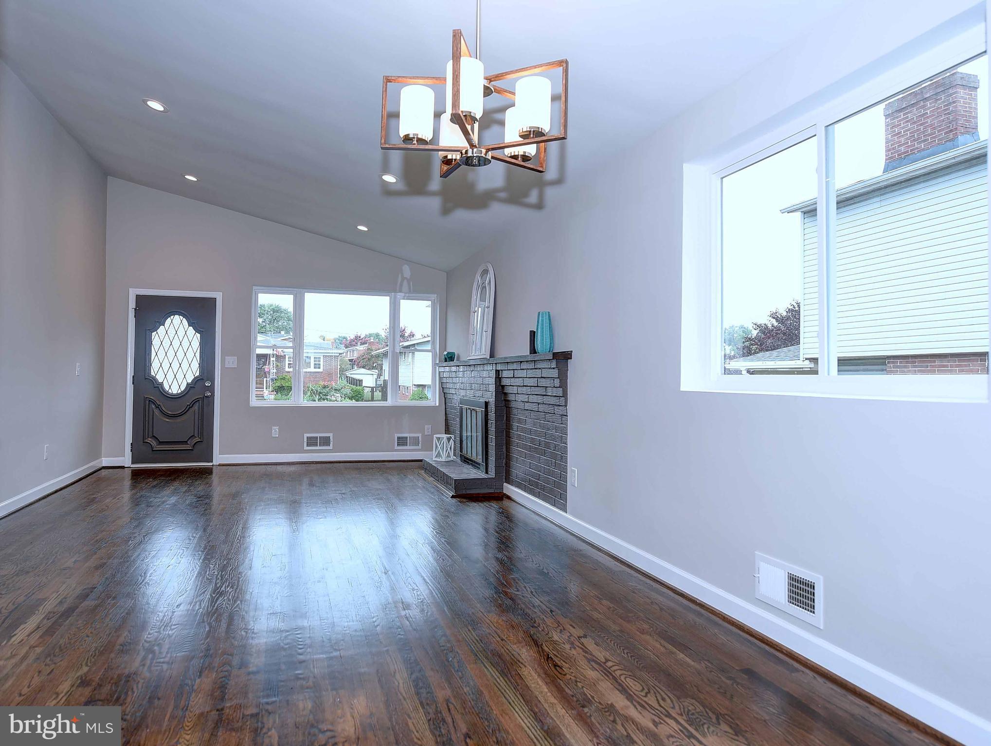 1213 Ridgeshire Road Baltimore, MD 21222 - Photo 9 of 30 wooden floor in an empty room with a window