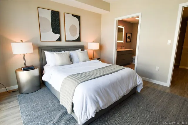 a bedroom with a bed and wooden floor