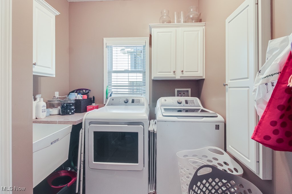 132 Timber Ridge Drive, Unit RDR Elyria, OH 44035 - Photo 21 of 41 Laundry room with cabinets, sink, and washing machine and dryer