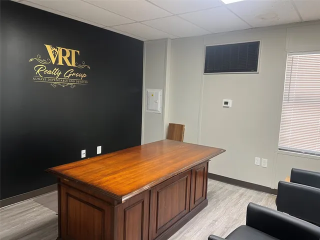 a room with pool table and windows