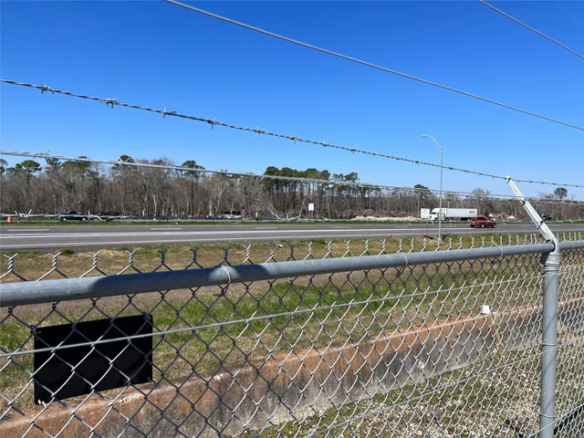 a view of swimming pool with outdoor seating and yard in the back