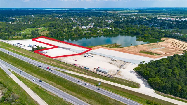 a view of a pool with a table and chairs under an umbrella