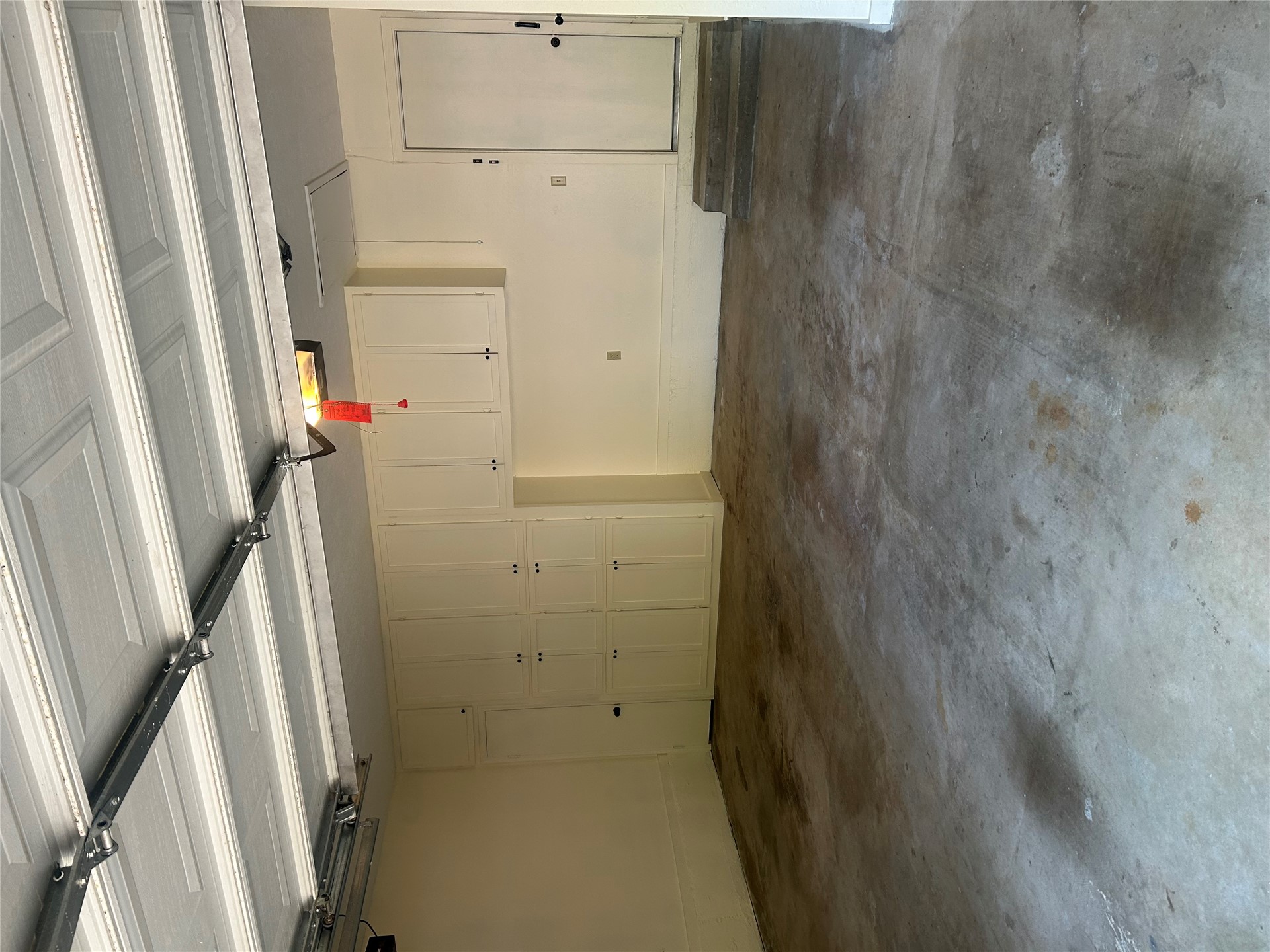 2913 Springdale Lane Duncan, OK 73533 - Photo 31 of 32 Integrated garage storage cabinetry, concrete flooring, and a single entry door