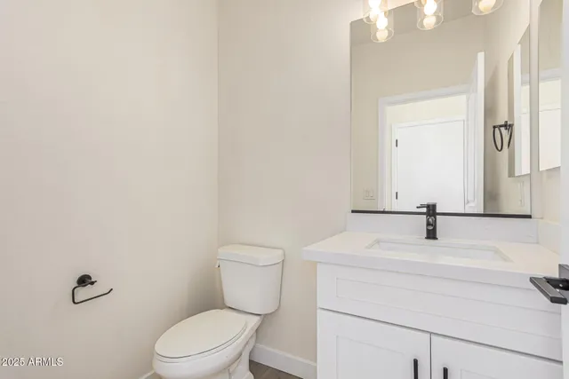 a bathroom with a sink toilet and mirror