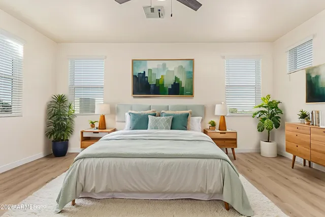 a bedroom with a large bed and a potted plant