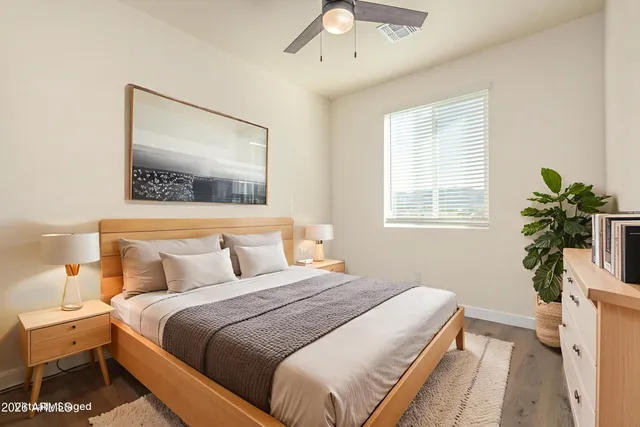 a bedroom with bed and a potted plant