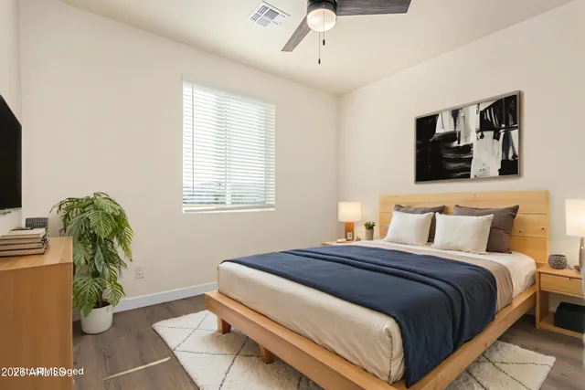 a bedroom with a bed and a flat screen tv