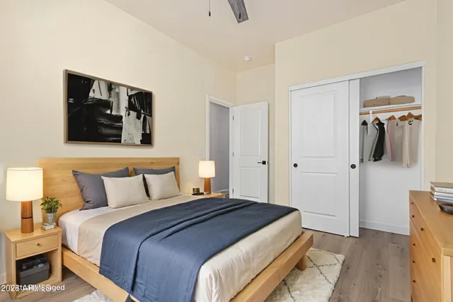 a bedroom with a bed and flat screen tv