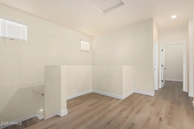 an empty room with wooden floor