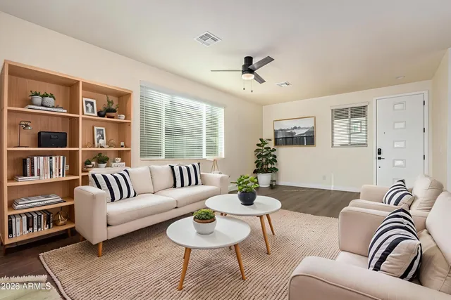 a living room with furniture and a book shelf