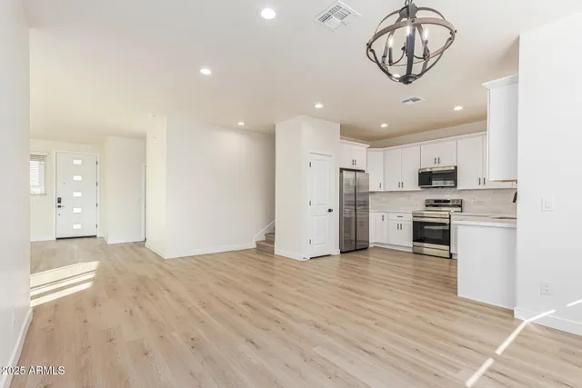 a view of a kitchen with a sink and stainless steel appliances