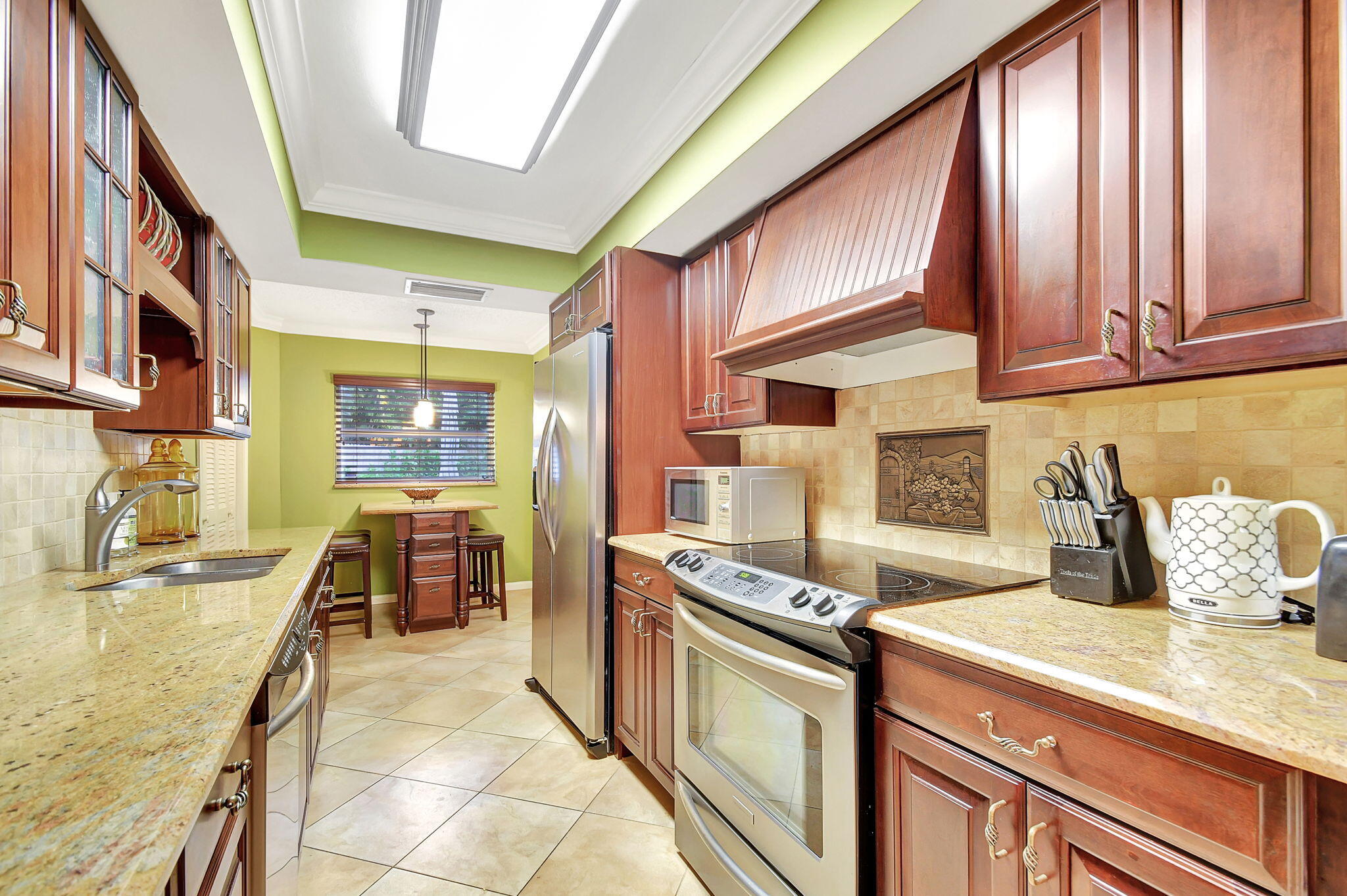 318 Southeast 7th Avenue, Unit 3 Delray Beach, FL 33483 - Photo 18 of 44 a kitchen with stainless steel appliances granite countertop a sink and a stove