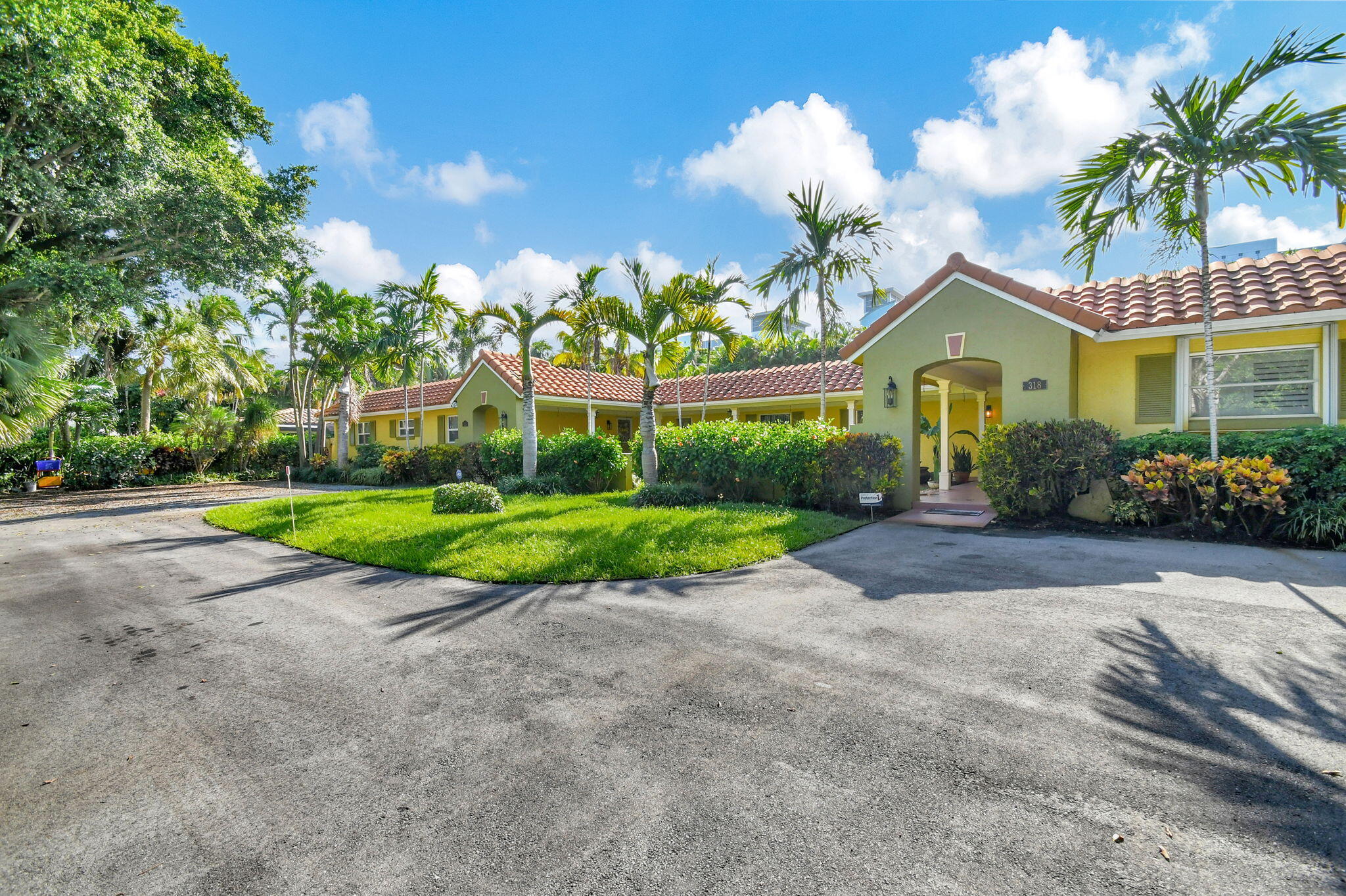 318 Southeast 7th Avenue, Unit 3 Delray Beach, FL 33483 - Photo 2 of 44 a view of a house with a big yard and large trees