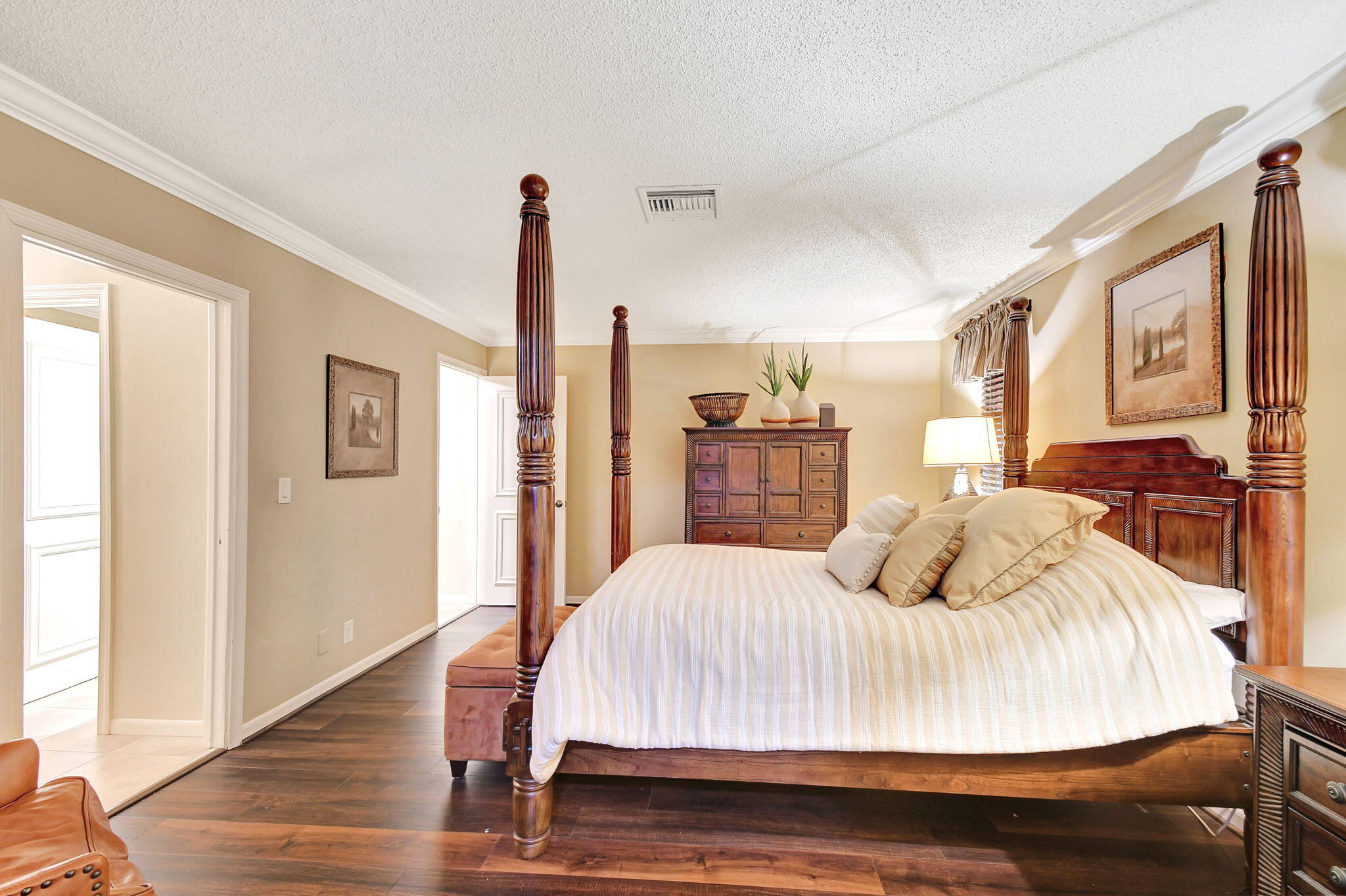 318 Southeast 7th Avenue, Unit 3 Delray Beach, FL 33483 - Photo 23 of 44 a bedroom with a large bed and a wooden floor