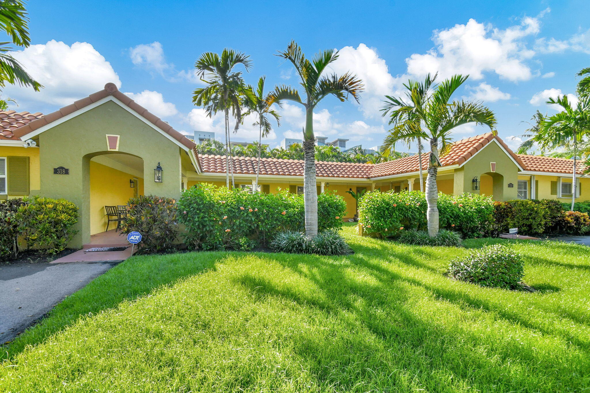 318 Southeast 7th Avenue, Unit 3 Delray Beach, FL 33483 - Photo 3 of 44 a front view of a house with a garden