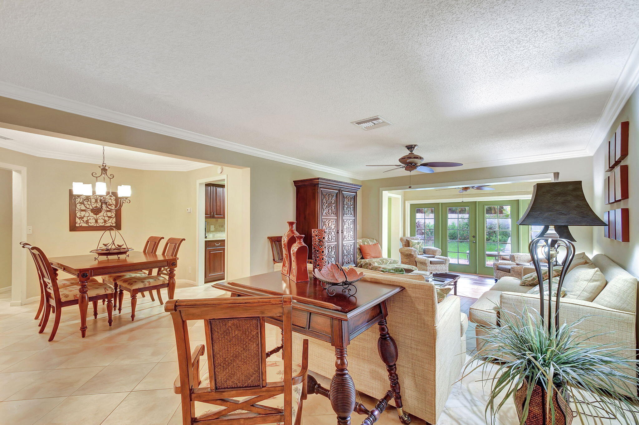 318 Southeast 7th Avenue, Unit 3 Delray Beach, FL 33483 - Photo 8 of 44 a dining room with furniture a chandelier and a flat screen tv