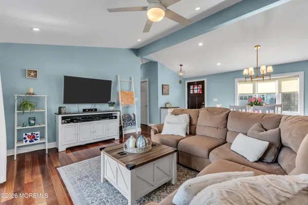 a living room with furniture and a wooden floor