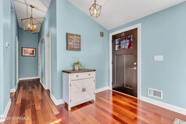 a view of hallway with wooden floor