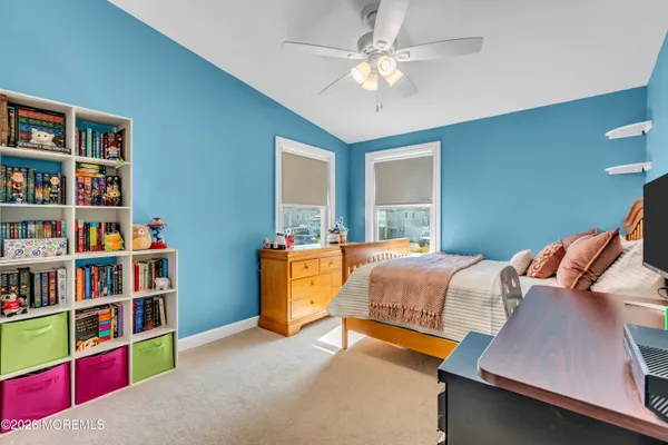 a bedroom with a bed and a couch
