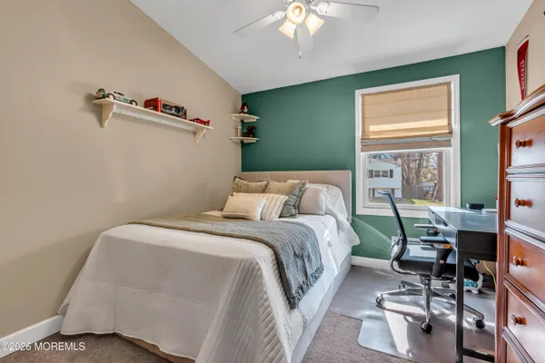 a bedroom with a bed and a dresser