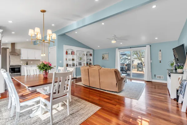 a living room with furniture a dining table and a potted plant
