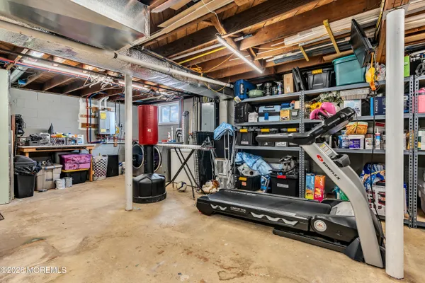 a view of a roof deck with table and chairs under an umbrella with wooden floor