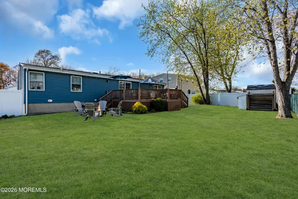 a backyard of a house with table and chairs