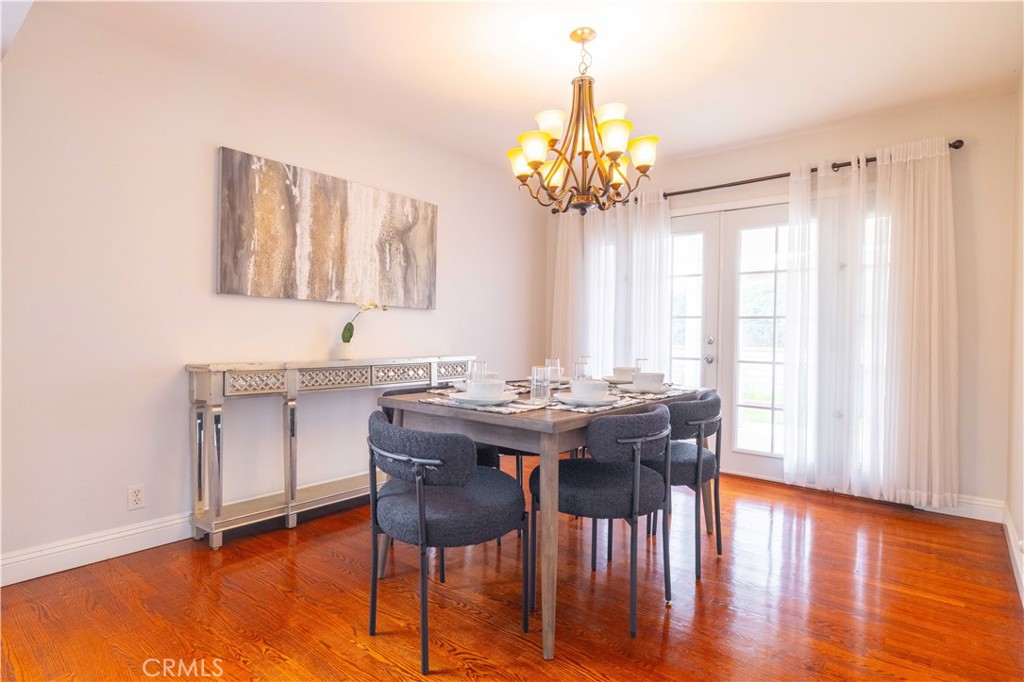 4759 Cll Estrada La Verne, CA 91750 - Photo 15 of 36 a view of a dining room with furniture a chandelier and wooden floor