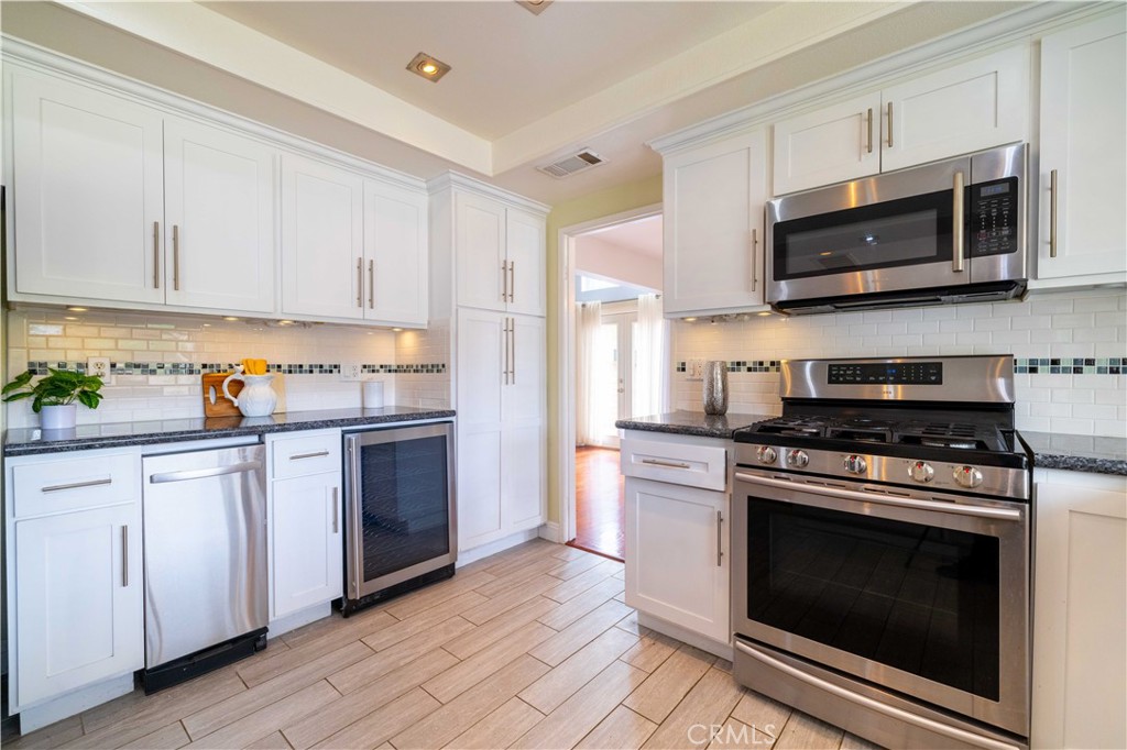 4759 Cll Estrada La Verne, CA 91750 - Photo 18 of 36 a kitchen with stainless steel appliances granite countertop a stove a microwave and cabinets