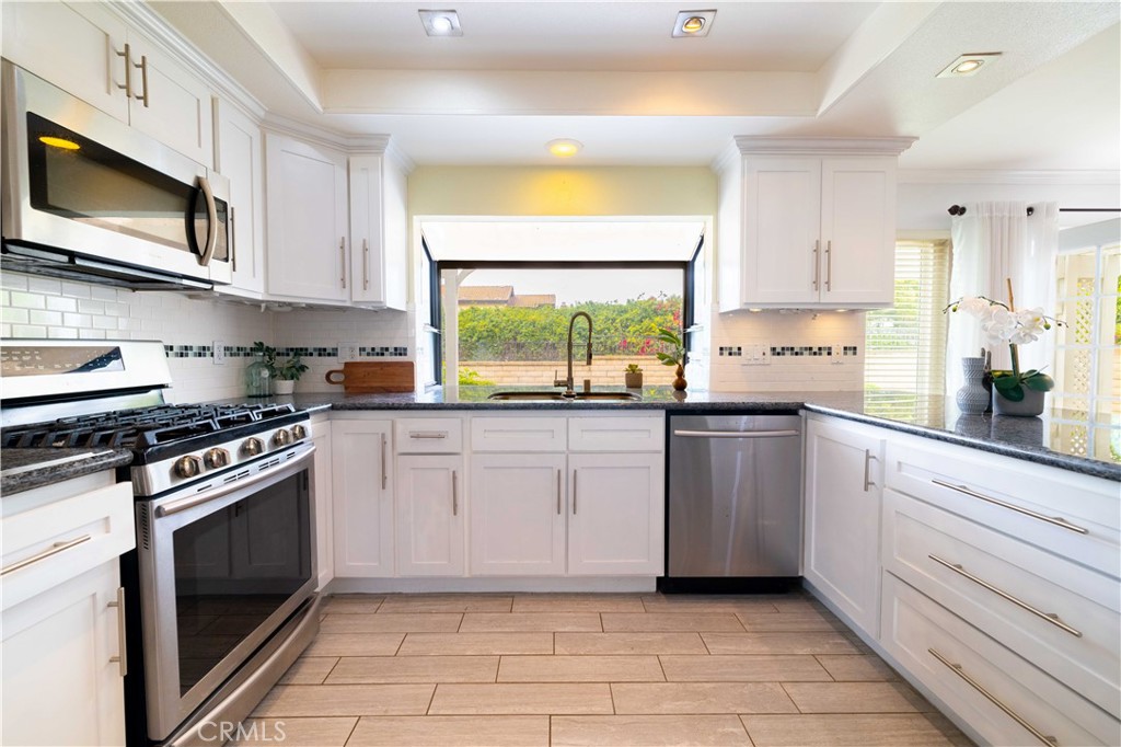 4759 Cll Estrada La Verne, CA 91750 - Photo 20 of 36 a kitchen with stainless steel appliances a stove a sink and a microwave