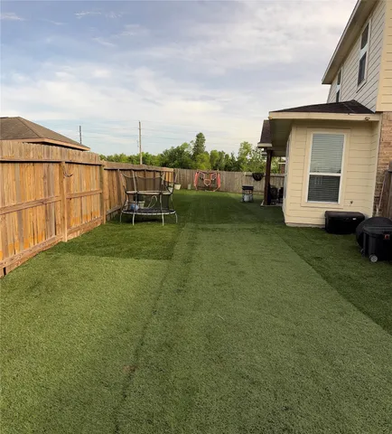 a view of a house with backyard and sitting area