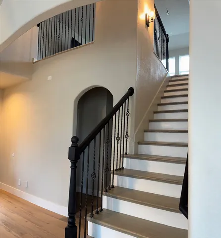 a view of entryway with wooden floor and stairs